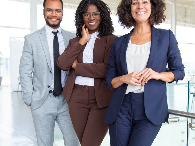 Three WeConsulting professionals in a modern office