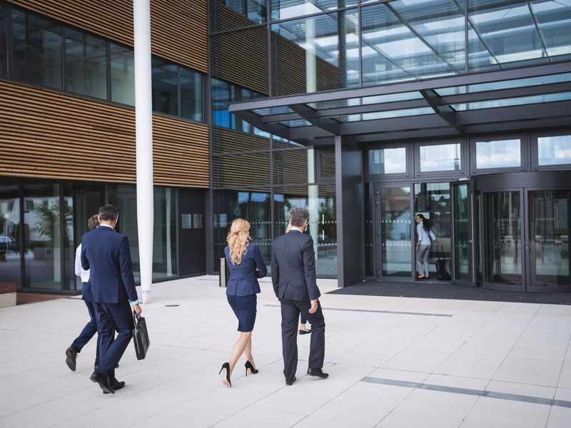 Professionals arriving at a modern office building